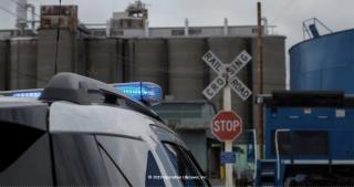 an image of a police car near a railroad crossing